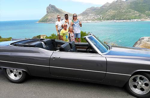 cape corporate tours cadillac tours and transfers guys sitting next to classic convertible cadillacs table mountain in background