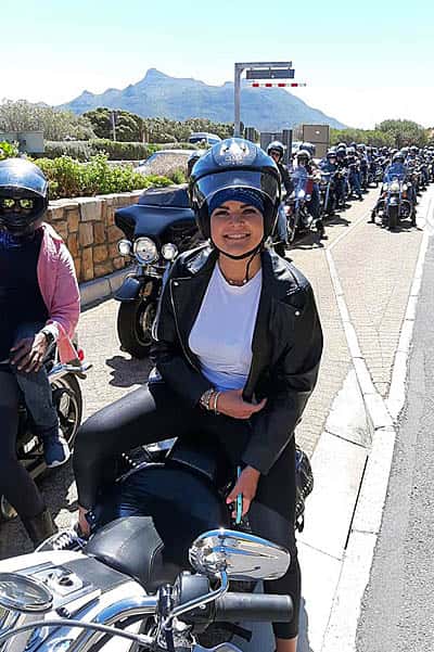 harley davidson tours lady on back of harleys lined up on road
