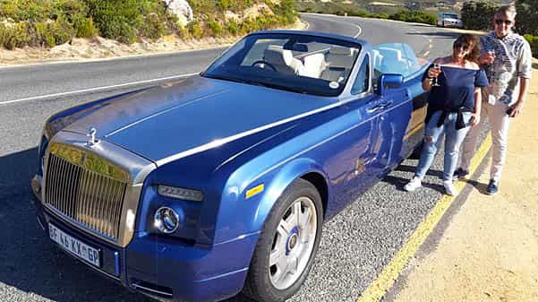 cape corporate tours executive chauffeur trips couple with champagne next to rolls royce phantom