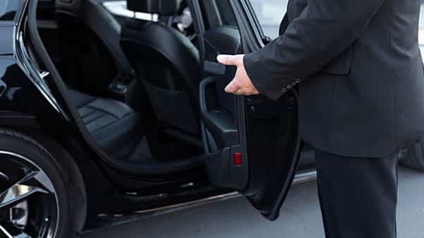 cape corporate tours executive chauffeur trips opening car door of luxury car