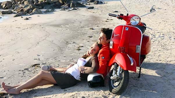 cape corporate tours scooter rentals couple next to red vespa on cape town beach