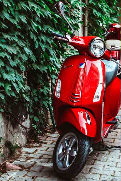 cape corporate tours scooter rentals couple next to red vespa parked in cape town