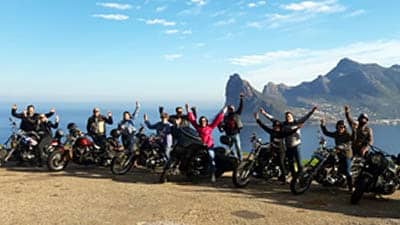 Cape corporate tours harley davidson chauffeur rides goup of people on harleys hout bay